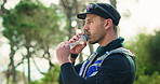 Water, runner and man in nature for fitness, exercise and training for marathon outdoor. Sports, athlete and person with liquid, minerals and bottle for wellness, hydration and health for workout