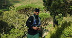Man, trail running and fitness in forest for workout, nature and outdoor for routine in summer. Person, athlete and challenge with cardio exercise, backpack and training for marathon in Australia