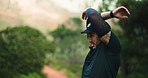 Man, trail runner and stretching arms in forest, exercise or ready for marathon training. Person, athlete and fitness routine with warm up for preparation with workout, outdoor or nature in Argentina