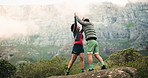 Celebration, mountain and couple with hike in nature for bonding, exercise or adventure together. Health, high five and man with woman for cheering on outdoor trekking with cardio workout in morning.