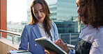 Business women, rooftop and tablet with discussion outdoor for planning, deal or conversation. Building, city or real estate with client, developer and documents for commercial investment on balcony