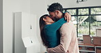 Love, kiss and couple in new home, celebration or excited for loan approval, homeowners and romance. Happy, man and affection for woman in house, relocation and moving in with boxes, bonding and care
