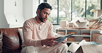 Stress, documents and reading with man on sofa for home loan rejection, foreclosure and risk. Debt letter, eviction notice and frustrated with person in living room of apartment for paperwork