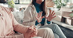 Hands, divorce and couple in home with argument, upset and unhappy in marriage with conflict or drama. Explaining, problem or mistake on couch with anger, doubt or infidelity in relationship crisis