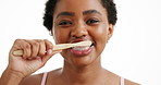 Oral care, face and black woman brushing teeth in studio for wellness, grooming or hygiene. Dental health, happy and portrait of African person with toothbrush for fresh breath by white background.