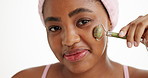 Face, jade roller and smile with black woman in studio for beauty, cosmetic wellness or skincare. Dermatology, facial and massage with African person isolated on white background for cosmetology