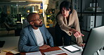 People, pointing and teamwork with computer in office, night and planning for investment on website. Working late, man and collaboration with woman for deadline, talk and financial analyst with tech