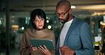 Teamwork, man and woman with tablet in office, pointing or discussion for investment pitch at night. Working late, people and collaboration with financial analyst for deadline, planning and strategy