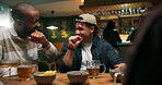 Happy, group of friends and laughing in pub for reunion, funny conversation and evening drinking. Comic jokes, fist pump and men together at party, carefree attitude and talking for weekend hangout
