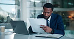 Business, black man and laptop with paperwork in office for case study, contract review or policy. Professional, lawyer or tech with documents at law firm for reading legal report or lawsuit evidence