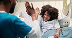 Doctor, consulting and kid with high five in bed for healthcare checkup, diagnosis or results. Man, medical nurse or child with teddy bear for health symptoms, questionnaire or survey in hospital