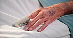 Hand, elderly person and pulse oximeter in hospital bed for blood levels, track oxygen or recovery. Healthcare, senior patient and medical tool in clinic to monitor health condition and critical care