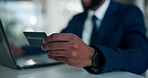 Hand, credit card and black man in office, laptop and payment with ecommerce. African person, fintech and employee in workplace, computer and purchase with online shopping, investment and banking