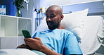 Phone, smile and black man in bed at hospital for typing message, medical update and recovery. Mobile, patient and rest in clinic with app for communication, social media and healing for healthcare