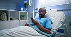 Mobile, smile and man in bed in clinic for typing message, laugh and medical update for recovery. African patient, phone and rest in hospital with app for meme, social media or healing for healthcare