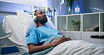 Rest, hospital and patient with headphones in bed for surgery recovery, music or healing podcast. Peaceful, black man and listening to audio playlist in inpatient clinic for medical wellness or radio