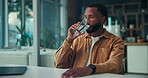 Drinking, water and business man in home with glass, hydration and self care for wellness. Thirsty, detox and African person on break with laptop, mineral liquid and nutrition for health benefits