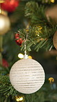 Christmas, tree and baubles in home for holiday, festive season and party celebration in house. Ornaments, xmas and decoration for December tradition, bokeh lights and new year event in living room
