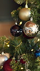 Bauble, ornament and closeup on Christmas tree, home and festive holiday event with creativity. Ball, present or hanging decoration for xmas season, tradition or interior for celebration at house
