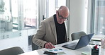 Business, documents and mature man on laptop for finance review, company revenue and budget report. Graph, corporate and person on computer for financial proposal, planning and statistics in office
