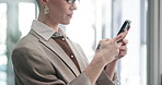 Office, typing and business woman with phone for social networking, online contact and communication. Professional, corporate and person on smartphone for message, research and website in morning