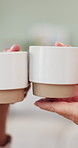Hands, couple and toast with coffee in home for relationship goal, bonding and anniversary. People, partnership and celebration with tea cup, drink and beverage for support, cheers or love in closeup