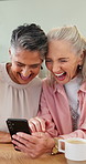 Senior women, friends and laugh with phone for research, social media and reading funny meme. Happy, elderly people and mobile app of comedy video, browsing website and message notification at house