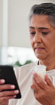 Senior woman, phone or research with medication for side effects, information or telehealth in home. Elderly, female person or browsing on mobile smartphone for pills, tablets or online prescription