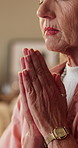 Hands, senior woman and praying at house for faith, devotion and worship God for guidance. Elderly person, spiritual mercy or prayer to Jesus christ for belief, Christian religion and holy confession