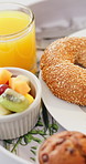 Food, fruit and breakfast with juice in morning for health, wellness and balanced meal in home. Nutrition, muffin and bagel with eggs and avocado for brunch with organic beverage in apartment.