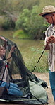 Couple, camping and stuck with tent set up in nature for travel, vacation and holiday. Woman, man and camper struggle to pitch shelter, problem or confused interracial people with challenge at river