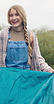 Face, set up and tent with woman outdoor on campsite for holiday, travel or weekend vacation. Getting ready, pitch and preparation with happy camping person in nature for getaway, hobby or wellness