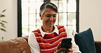 Phone, laugh and senior woman on sofa in home for networking, social media or communication. Happy, relax and elderly female person with cellphone for texting online with mobile app in living room.