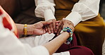 Women, friends and holding hands for comfort on sofa with trust, compassion and support for grief. Mature people, consoling and sympathy for bad news, mourning loss and understanding sorrow at house