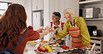 Cooking, senior friends and cheers with wine for celebration, laugh and culinary lesson in home. Kitchen, group and happy old women toast glass with drinks for bonding, funny joke or gastronomy class