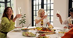 Cheers, happy and friends with dinner in home for bonding, fun and connection together on weekend. Smile, champagne and group of mature women with alcohol toast for celebration supper in apartment.