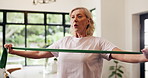 Breathing, fitness and resistance band with old woman in living room of home for rehabilitation. Equipment, exercise and stretching with senior person in apartment for strength training or workout