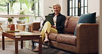 Reading, online and old woman with tablet, lounge or chill on couch, entertainment and break in home. Browsing, ebook and senior person with smile for funny novel, retirement and laugh with tech