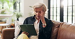 Annoyed, tablet and elderly woman on sofa with problem, online issue or stress in technology. Idea, thinking or old person in home with internet struggle, glitch or network error on digital app.