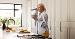 Dancing, senior woman and eating in kitchen with food, happiness and energy from breakfast nutrition. Smile, meal prep and elderly person at home with fruit salad, morning snack and balanced diet.