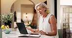 Laptop, freelancer and mature woman on video call with accounting paper, finance chat or goodbye. Computer, remote work and happy auditor in virtual meeting for budget, bokeh and wave in home kitchen