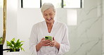 Bathroom, phone and happy woman laugh with morning routine, scroll message or social media. Robe, home and mature person with mobile for funny meme, spa blog and reading text with comedy on internet