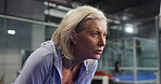 Padel, senior woman and tired on court with sweating, breathing or intense workout challenge. Retirement fitness, elderly person and exhausted at indoor tennis club with match endurance or overworked