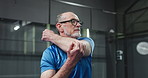 Fitness, stretching and old man at indoor court, health benefits and sporty hobby in playing padel. Exercise, commitment and elderly person with glasses at tennis arena, match practice and training.