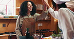 Cooking class, woman and high five with chef in kitchen for success, learning and gastronomy goal. People, culinary lesson and celebration in workshop for target, well done and excited in restaurant