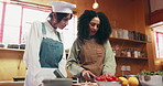 Cooking class, cutting and woman with chef in kitchen for learning culinary skills, cuisine and dinner recipe. Lesson, tutorial and people with vegetables, ingredients and food for nutritional meal