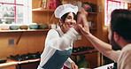 Cooking class, woman and high five with chef for success, learning and gastronomy goal in kitchen. Man, culinary lesson and celebration in workshop for target, well done and excited in restaurant