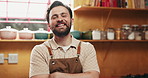 Happy man, chef and face with confidence for cooking class, skill or hospitality service in kitchen. Portrait, male person or culinary artist with apron, smile or arms crossed for food or catering