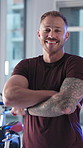 Face, athlete and man with arms crossed, gym or confident for workout goals, happiness and wellness. Health club, membership and person with sportswear for fitness, laughing and determined in USA