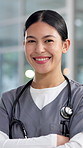 Nurse, happy and face of woman in hospital with crossed arms for medical service, career and job. Healthcare, professional and portrait of person with confidence for wellness, clinic and about us
